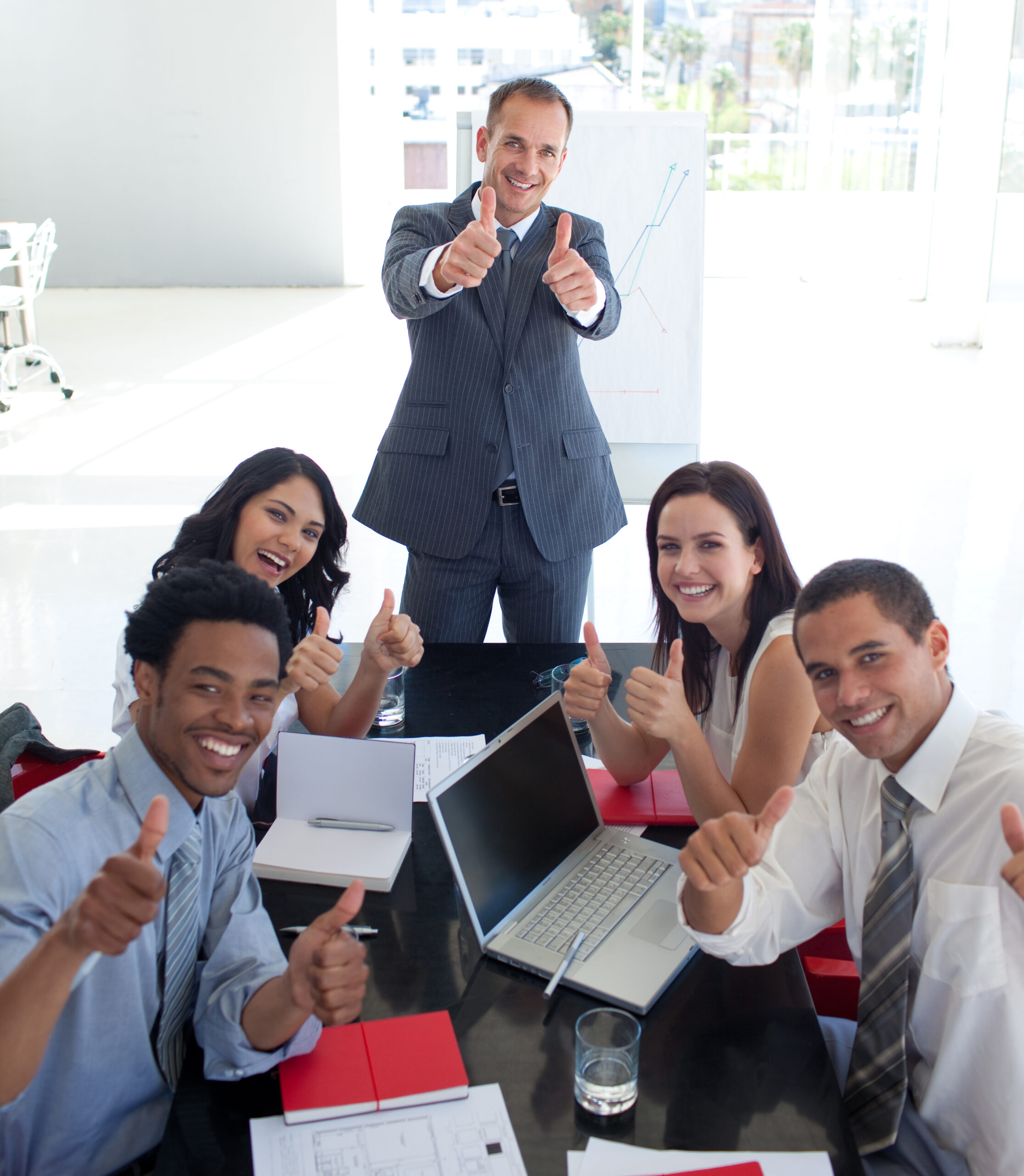 Business team in a meeting with thumbs up